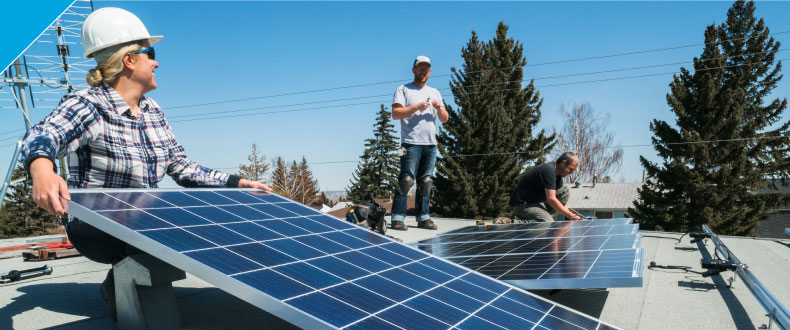 Two men carrying a solar panel